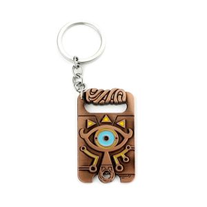 Chaveiro em metal acobreado do Purah Pad de Zelda, com o Olho Sheikah azul e argola prateada