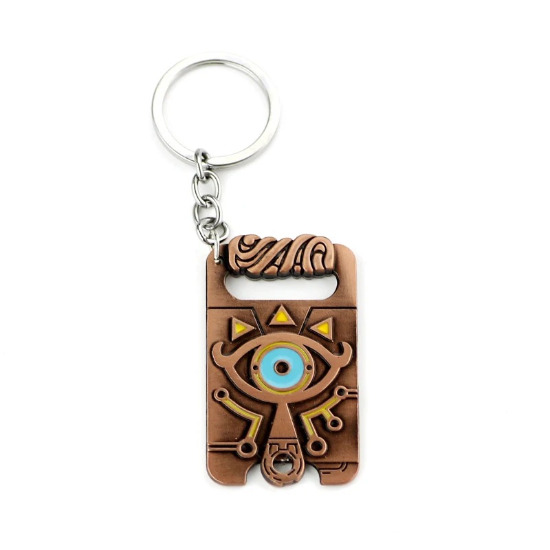 Chaveiro em metal acobreado do Purah Pad de Zelda, com o Olho Sheikah azul e argola prateada