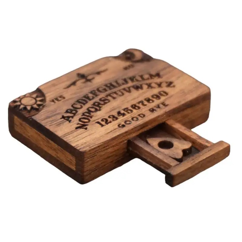 Mini tabuleiro Ouija de madeira com a gavetinha aberta mostrando o ponteiro