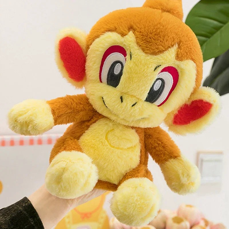 Pelúcia do Chimchar, de Pokémon, segurada em uma das mãos, mostrando o pelo macio