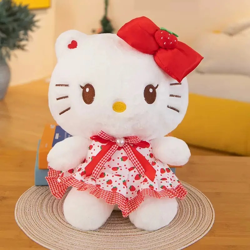 Pelúcia da Hello Kitty com laço vermelho e vestido branco e vermelho estampado de morangos
