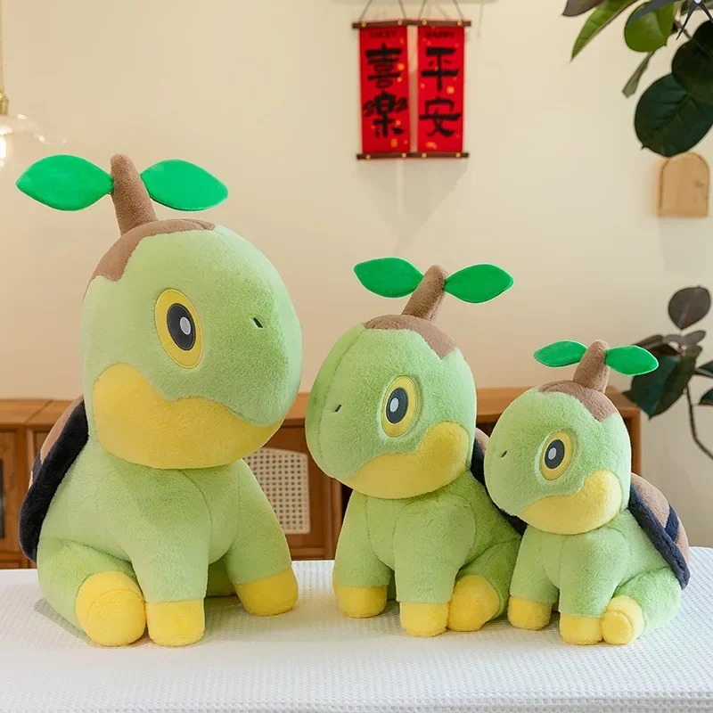 Três pelúcias do Turtwig, de Pokémon, de tamanhos diferentes lado a lado